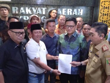 Ketua DPRD Provinsi Lampung Ahmad Giri Akbar menyerahkan salinan keputusan penetapan harga minimal singkong kepada perwakilan pengunjuk rasa di gedung DPRD Provinsi Lampung, Senin (13/01/2025) 